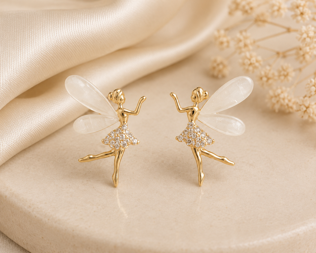 Angel Wing Earrings featuring gold-tone fairy figures with translucent white wings and crystal detailing