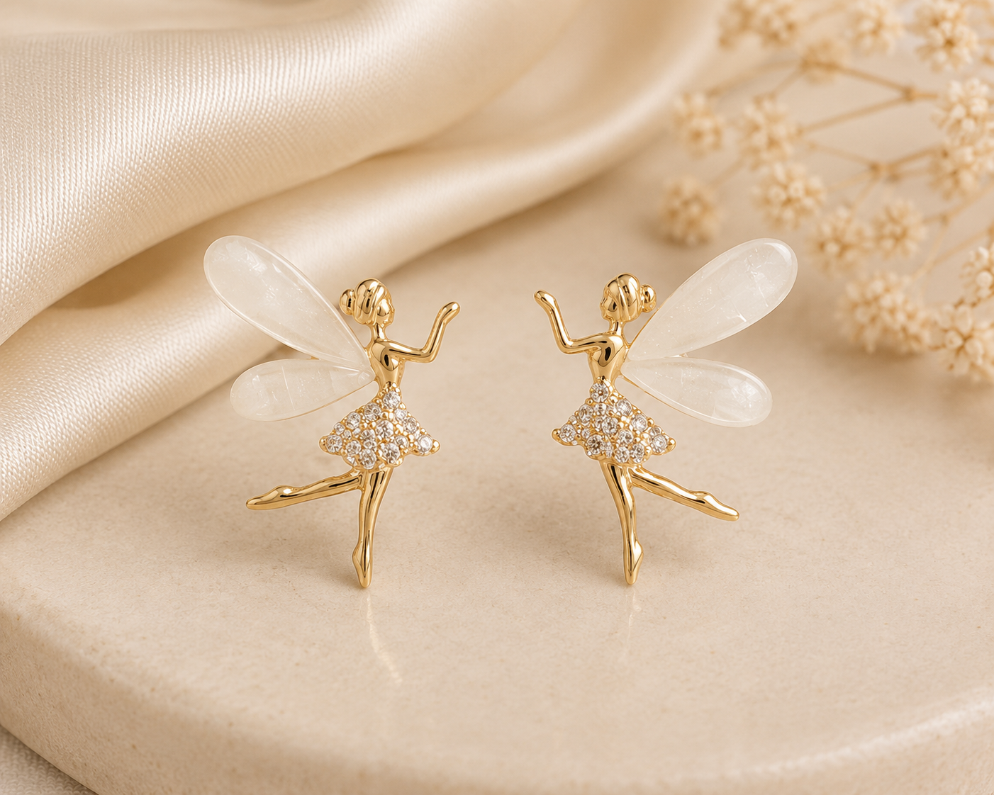 Angel Wing Earrings featuring gold-tone fairy figures with translucent white wings and crystal detailing