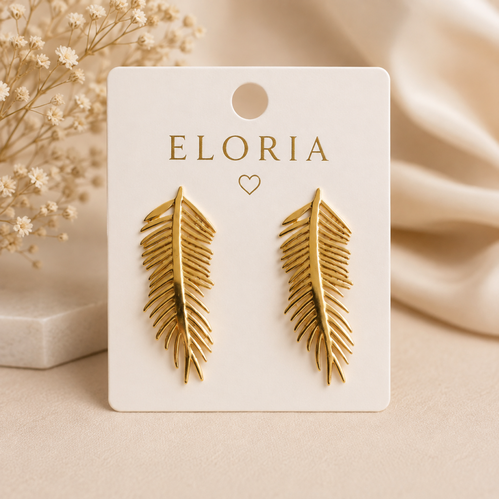 ELORIA gold leaf earrings displayed on a white jewellery card