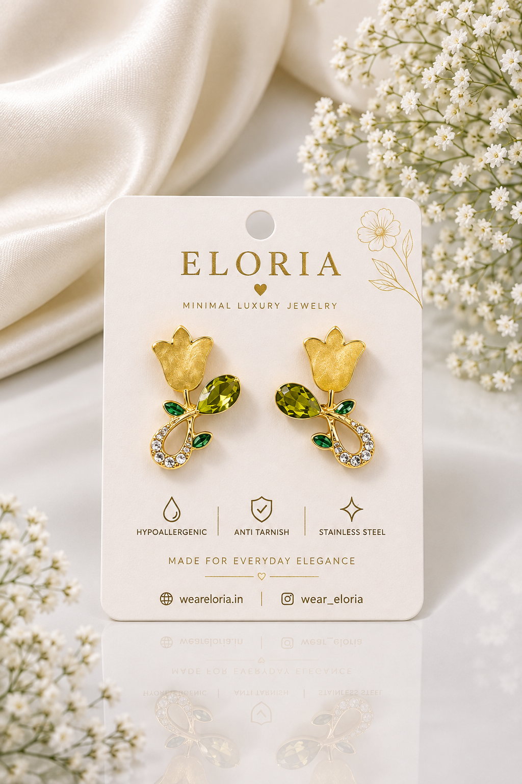 ELORIA Golden Rose and Green Gem Drop Earrings on luxury jewelry display card