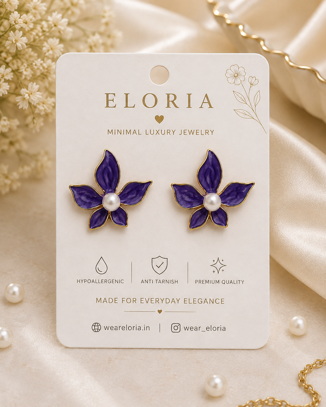 Purple floral pearl stud earrings displayed on an ELORIA jewelry card