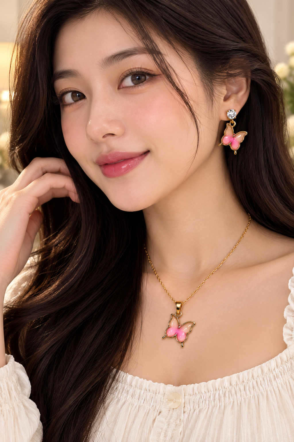 ELORIA Rosé Butterfly Charm Set worn by a woman featuring pink butterfly earrings and matching necklace